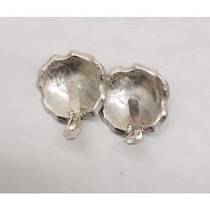 This is part of Chairish’s Costume Jewelry assortment.  1960s Modernist rhodium plated rough metal look domed amorphic with flared edges clip earrings. Marked "Mosell." Measure: 1 1/2 inches long by 1 1/2 inches wide. Excellent condition-dark spots in the pictures are just reflections. Dark Spots, Rhodium Plated, Costume Jewelry, Clip On Earrings, 1960s, Plating