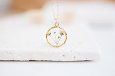 - N E C K L A C E -The small branch of Baby's Breath flower inside the necklace! Flowers protected with crystal resin that helps to retain its nature beauty for a long time. This is a stunning statement piece for any flower lover! Real flowers necklace for mother and daughter, for sisters or bridesmaids gift.The chain length is adjustable! You chose the length!Diameter : 20mm diameterMaterials: Resin / Real flower / silver 925 necklace / silver 925 chain------------------------------------------ Nature-inspired Birth Flower Jewelry For Everyday, Dainty Birth Flower Jewelry Gift For Her, Dainty Birth Flower Jewelry As A Gift For Her, Delicate Birth Flower Charm Necklaces, Dainty Birth Flower Jewelry As Gift For Mom, Dainty Birth Flower Jewelry For Mom, Minimalist Flower Pendant Jewelry For Mom, Minimalist Flower Pendant Jewelry Gift For Mom, Minimalist Flower Pendant Jewelry As Gift For Mom