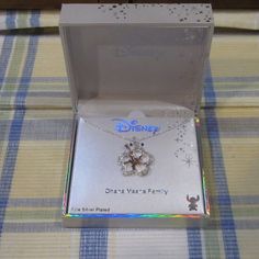 the disney necklace is in its box on the table