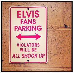 a red and white sign that says elvis fans parking violators will be all shock up