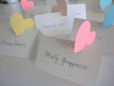 several cards with hearts on them sitting on a table