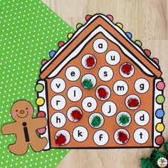 a gingerbread house cut out on top of a wooden floor next to a green polka dot background