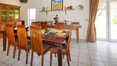 the dining room table is set with place settings for six people and has wooden chairs