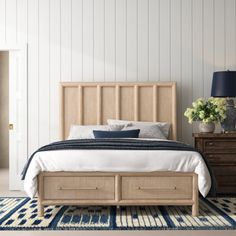 a bedroom with white walls and blue accents