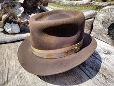 My "Grubby Bowler" hat in brown. Thick wool felt hand blocked and shaped by me. Layered cotton grosgrain ribbons for the hat band with a raw edge brim. Calf skin inner sweatband with a cotton liner. The crown height is 5" and the brim is 1 7/8".  Size is 7 1/8. Here I am making this hat  https://youtu.be/-aT3FD1g2dI My hats are all one of a kind. I make them all myself one at a time.  The hat you see in the pictures is the exact hat you will receive. All my hats are made from either wool, rabbit or beaver felts. I use all cotton for the thread, ribbon and brim bindings. I use reeded leather sweatbands for a very comfortable and durable fit.  Let me know if you have any questions. Thanks for looking. If you would like to order a hat in a different color or size or with a different hat band Brown Felt Hat Band For Country Events, Brown Felt Hat Bands For Rodeo, Brown Wool Top Hat For Fall, Brown Fedora Hat Bands Made Of Felt, Brown Felt Hat Band For Rodeo, Brown Flat Crown Felt Hat For Outdoor, Western Brown Felt Hat Bands, Country Style Brown Fur Felt Hat Bands, Country Style Wool Hat Band In Brown