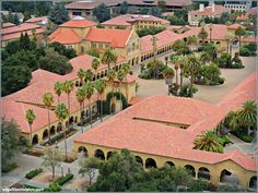 an aerial view of a building with palm trees