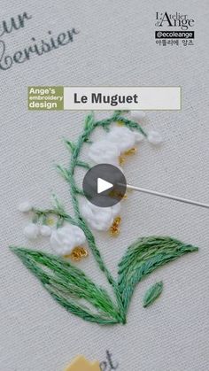 the video is showing how to make a flower with beads and thread on fabric,