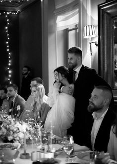 a group of people sitting around a dinner table