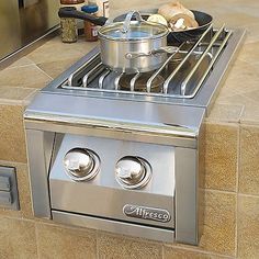 a stainless steel stove top oven with pots and pans on it