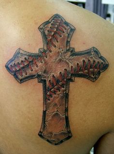 a baseball themed cross tattoo on the back of a man's upper arm and shoulder