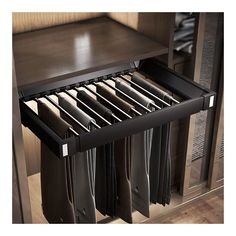 an open drawer in a cabinet filled with folded shirts and pants on it's bottom shelf