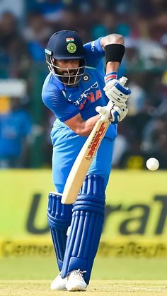 a cricket player hitting the ball with his bat