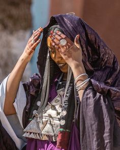 a woman with her hands on her head in the middle of an open air area