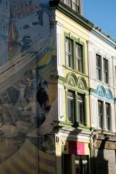 an old building with a mural on it's side