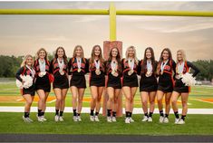 the cheerleaders are posing for a photo on the field