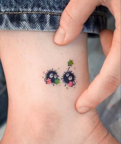 two small tattoos on the side of a woman's stomach