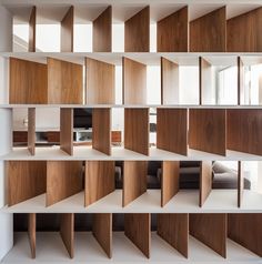 the bookshelf is made out of wood and has many shelves on each side