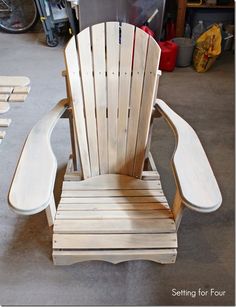 a chair made out of wood sitting on top of a garage floor next to other pieces of furniture