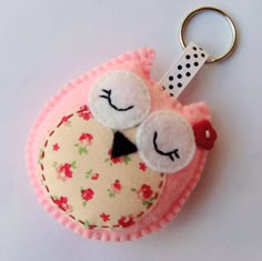 a keychain with a cute little bird on it's face and eyes