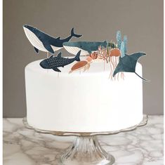 a white cake topped with lots of different types of sea animals