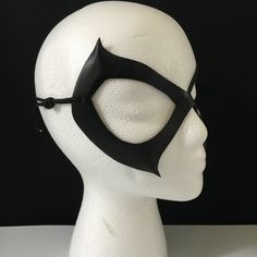 DESCRIPTIONSleek & sexy, lightweight leather Black Cat mask is an awesome costume accessory for Felicia Hardy, Ms. Marvel, Batgirl, Catwoman Cosplay or Halloween. Great convention mask; For villian & superhero cosplay, Halloween or Comicon. Spice up Valentine's Day! Any color. Waterproofed leather, glossy or matte finish, & several choices to affix the mask (cord, elastic, ribbon, waterproof cord, stick, or no holes for adhesive). Measurements: 7" high x 5" wide (tallest & widest Gothic Masks And Prosthetics For Cosplay With Adjustable Fit, Gothic Masks And Prosthetics For Costume Party, Adjustable Masks For Halloween Cosplay, Adjustable Punk Masks And Prosthetics For Cosplay, Punk Style Adjustable Masks And Prosthetics For Cosplay, Gothic Adjustable Masks And Prosthetics For Costume, Masquerade Eye Mask For Cosplay Events, Cosplay Events Eye Mask For Masquerade Costume, Cosplay Events Masquerade Eye Mask