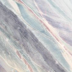 a close up view of marble with different colors and patterns on it's surface