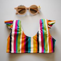 a bathing suit and sunglasses on a table