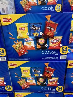 several boxes of chips are stacked on top of each other in the same store display