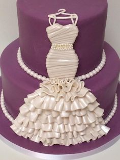 a purple cake with a white dress on top