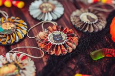 several decorative items are displayed on a table with ribbons and decorations around them, including brooches