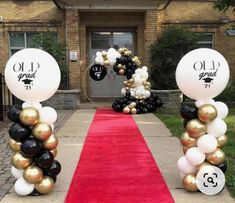 an entrance decorated with balloons and streamers for the graduation party at old grad