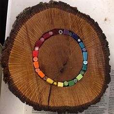 a piece of wood that has some colorful buttons on it