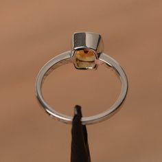 It is a natural citrine ring. The main stone is 6 mm*8  mm cushion cut. weight about 1.30 carats.The basic metal is sterling silver and plated with rhodium.To change the metal to a solid gold (white/rose) or platinum is also available, please ask for a quotation if you want.You can also go to my shop Home for more elegant rings: https://www.etsy.com/shop/godjewelry?ref=hdr_shop_menu More citrine rings:https://www.etsy.com/shop/godjewelry?ref=seller-platform-mcnav&search_query=citrineCustomiz Citrine Engagement Ring, Citrine Ring Engagement, Elegant Rings, Sunflower Ring, Alexandrite Ring, Yellow Gemstones, Citrine Ring, Peridot Ring, Natural Citrine