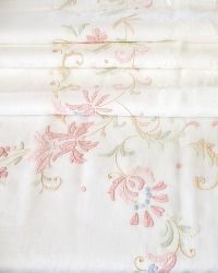 two white sheets with pink and blue flowers on them