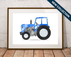 a blue tractor on a white background in a wooden frame with the words new collection above it