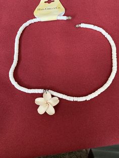 a white bracelet with a flower on it