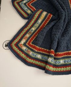 a crocheted blanket laying on top of a table