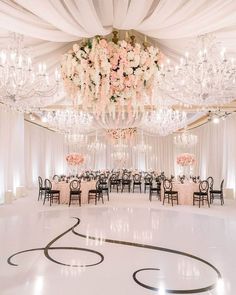 an elegant ballroom with chandeliers and flowers on the ceiling is ready for guests to arrive