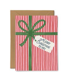 a red and white striped christmas card with a green ribbon