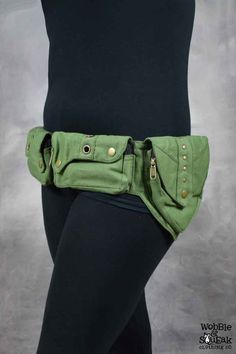 a woman is wearing a green belt with gold buttons on the front and side of her waist