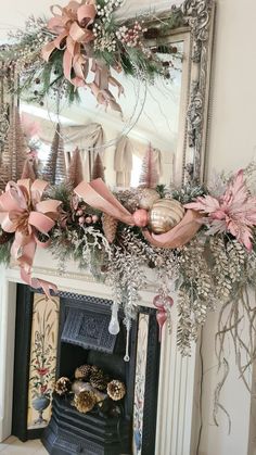 a fireplace mantel decorated with pink and gold decorations