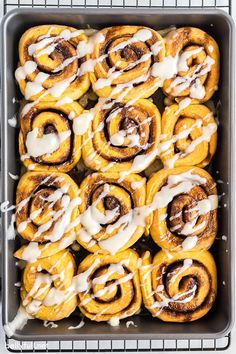 cinnamon rolls with icing in a baking pan