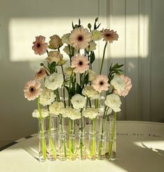 a vase filled with lots of white and pink flowers