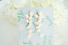 These lovely earrings are handmade from white clay, and feature a beautiful lily of the valley design. They're perfect for any special occasion, from weddings to bridal parties. The earrings hang from 18k gold-plated hooks, and each one is accented with a delicate pearl. They're truly unique and will make a cherished gift for any lucky lady. Handmade clay earrings,each earrings need long time to make  Length:    6CM     width:2CM Shipping policy  Free shipping  with  Non Tracking canadapost  mai Whimsical Dangle Earrings For Wedding, Whimsical Dangle Wedding Earrings, Whimsical Flower Earrings For Wedding, Whimsical White Wedding Earrings, Clay Lily, Flower Earrings Wedding, Fairy Earrings, Lily Of The Valley Flowers, Valley Flowers