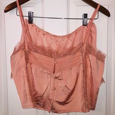 “Coral Mist” Colored Free People Cropped Tanktop And Short Pj Set. Very Silky Feeling, Light Weight, And Loose Fitting Material. Lacey Details On Top (Lace Strips Like Front Also Down Back Of Tank Top) And Around Bottom Of Bottom. Elastic Waist Band On Bottoms. Straps On Tank Top Are Adjustable. Size Xs. 100% Nylon. New With Tags. Pink Feminine Cami Crop Top, Pink Sleeveless Crop Top For Loungewear, Feminine Lace Trim Tops For Pajama Party, Feminine Camisole Top For Pajama Party, Pink Feminine Sleep Tops, Feminine Pink Sleep Tops, Feminine Tops For Summer Pajama Party, Camisole Top With Lace Trim For Pajama Party, Pink Tops With Built-in Bra For Loungewear