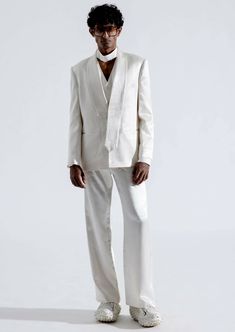 Elevate your style with our alabaster blazer. This classic straight-cut blazer, crafted from high-quality white vegan mashru fabric, is a testament to timeless sophistication and remarkable comfort. The blazer showcases an asymmetrical shawl collar with tie-shaped ends, adding a unique touch of refinement to your ensemble. Chic White Outerwear With Pressed Crease, White Structured Single-button Blazer, Modern White Blazer With Hidden Button Closure, Modern White Blazer, White Blazer With Pressed Crease For Fall, White Structured Blazer For Formal Occasions, Modern White Single Button Blazer, White Structured Business Blazer, White Pressed Crease Blazer For Fall