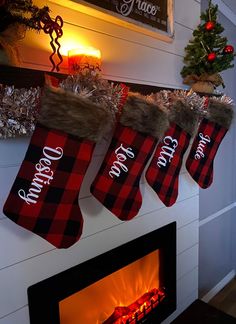 christmas stockings hanging from the fireplace with red and black plaid