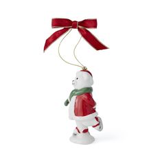 a christmas ornament with a red ribbon and a white teddy bear holding a green scarf