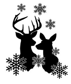 two deer standing next to each other in front of snowflakes