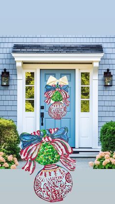 a blue front door decorated with christmas decorations